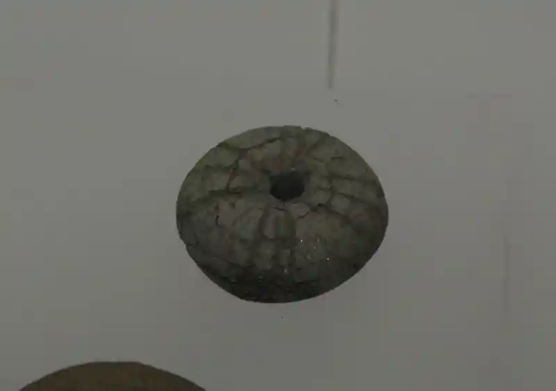 Cross or solar disc on top of claystone.